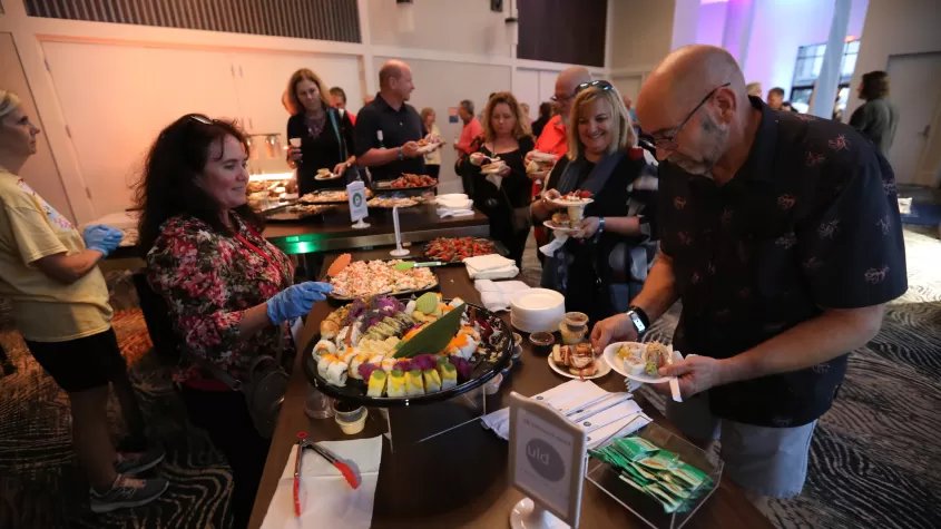A guest is served an array of hors d&#039;oeuvres during our opening night VIP event.