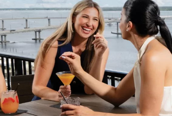 Enjoying cocktails at a rooftop bar on the river
